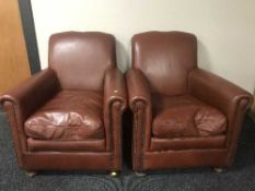 A pair of leather club armchairs