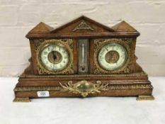An antique oak bracket clock with gilt and enamelled dial, fitted with a barometer,