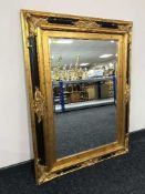 A black and gilt framed overmantle mirror