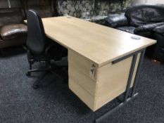 A single pedestal desk with swivel chair