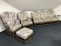 A four piece Ercol lounge suite comprising of settee,