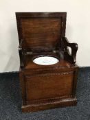 A Victorian mahogany commode with a ceramic liner