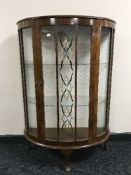 A walnut d-shaped display cabinet