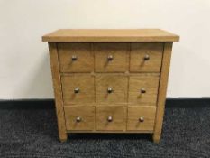 A contemporary oak three drawer chest