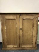 A reclaimed pine two door cupboard