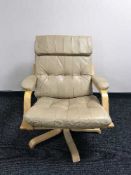 A beech framed leather swivel relaxer chair