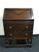 An oak bureau fitted with two drawers