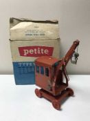 A boxed Petite Typewriter together with a vintage Triang tin plate crane