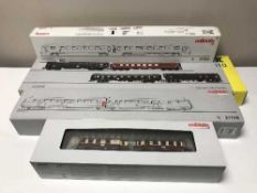 Three Marklin diesel rail cars 33762, 37770, 37707 together with a Trix passenger car set 23394,