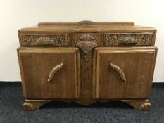 An early twentieth century carved oak sideboard