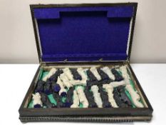 An oak canteen containing a set of chess pieces