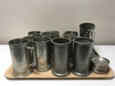 A tray of pewter and stainless steel tankards, pin dishes,