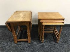 An oak drop leaf table and nest of oak tables