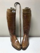 A pair of WW1 issue brown military boots with wooden trees together with a miniature cane with