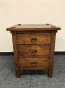 A hardwood chest of three drawers
