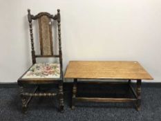 An antique turned oak bergere hall chair together with a rectangular oak coffee table