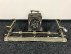 An antique brass fire curb together with a metal embossed coal receiver with liner