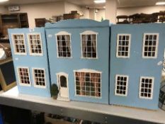 A triple section doll's house together with a quantity of dolls furniture
