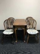 A walnut drop leaf table and four oak kitchen chairs