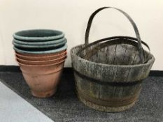 An oak metal bound barrel planter together with ten assorted plastic plant pots