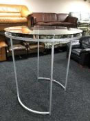 A circular contemporary glass topped clothes rail