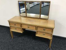 A late twentieth century kneehole dressing table with stool fitted with five drawers