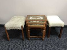 A nest of three teak tiled tables and two teak dressing table stools