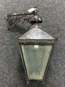 A vintage metal wall lantern with brackets