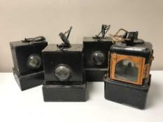 Four metal railway lamps