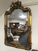 An ornate gilt framed mirror with cherub decoration