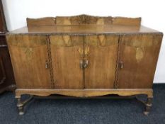 An antique walnut four door sideboard
