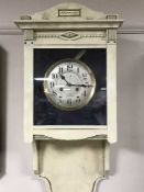 A cream and gilt painted wall clock