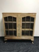 A walnut double door display cabinet