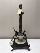 An antique brass column table lamp on marble base with cherub decoration