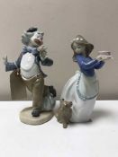 A Nao figure - Clown smelling a flower together with a Nao figure girl with birthday cake