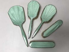 A five piece silver and enamel dressing table brush set