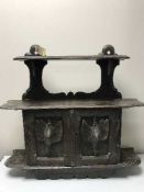 An early 19th century carved oak gamekeeper's cabinet