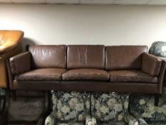 A late twentieth century brown leather three seater settee