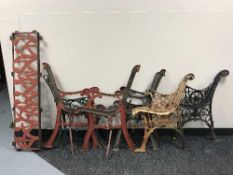 Four sets of cast metal bench ends together with a cast metal bench back