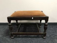 An oak upholstered oversized footstool