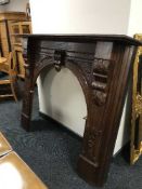 A carved mahogany fire surround