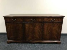 An inlaid mahogany triple door sideboard
