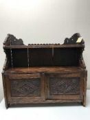 A carved 19th century spice cabinet