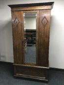 An Edwardian oak mirrored wardrobe