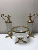 A pair of cut glass and brass claret jugs together with matching fruit bowl