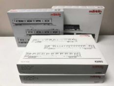 Three Marklin rail car packs, 37504, 42993, 42953, together with a stake car set 46921,