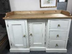 A painted pine inverted break-fronted sideboard