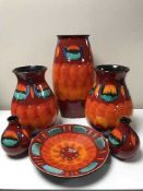 Six pieces of Poole volcano red pottery