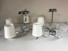 Two contemporary chrome five way light fitting together with one other,