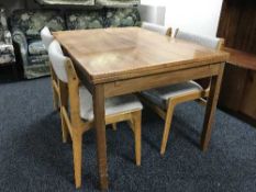 A walnut extending table and four chairs